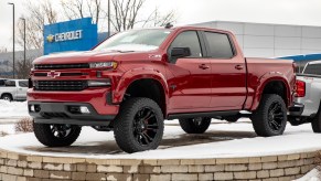 Pictured is a red 2021 Chevy Silverado outdoors.