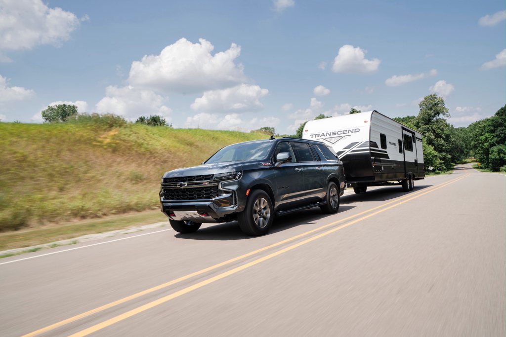 2021 Chevrolet Suburban Z71 hauling a trailer down the road