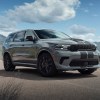 A gray-with-black-stripes 2021 Dodge Durango SRT Hellcat parked by a mountain lake