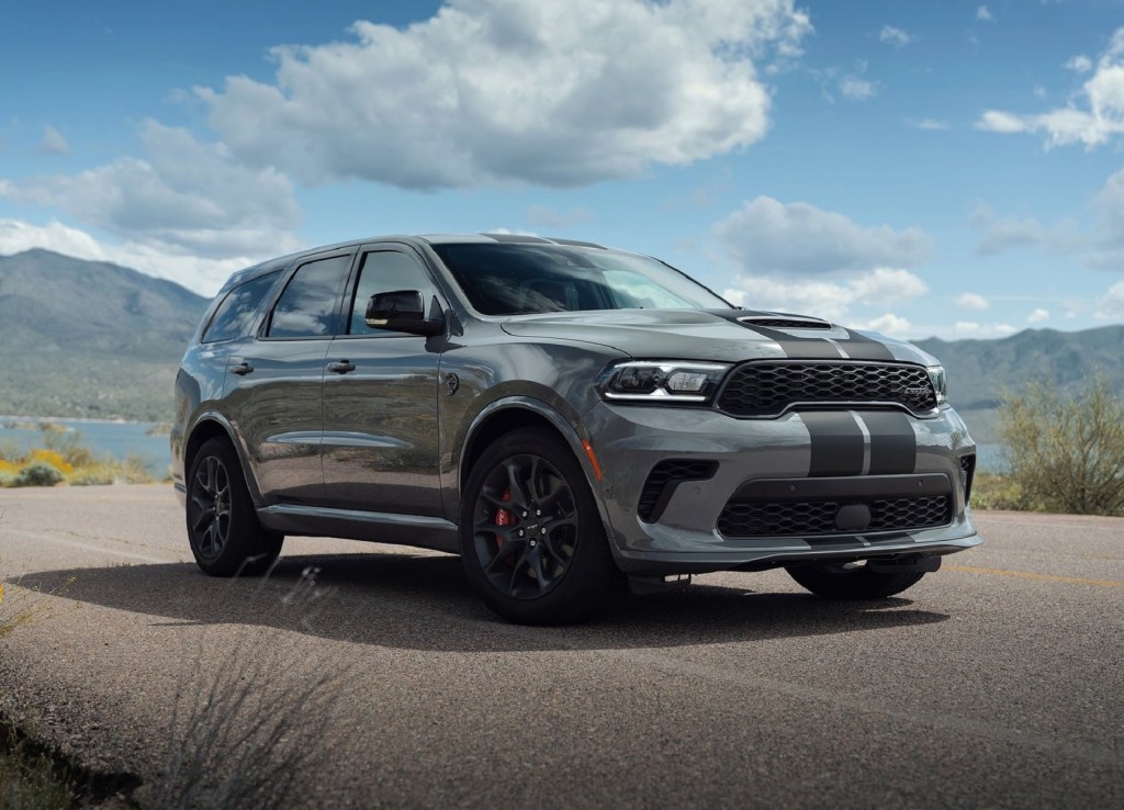 A gray-with-black-stripes 2021 Dodge Durango SRT Hellcat parked by a mountain lake