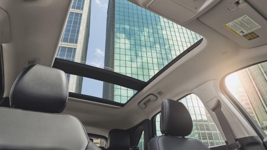 An interior view of a 2021 Ford Escape Titanium compact crossover SUV with gray leather seats and a panoramic sunroof