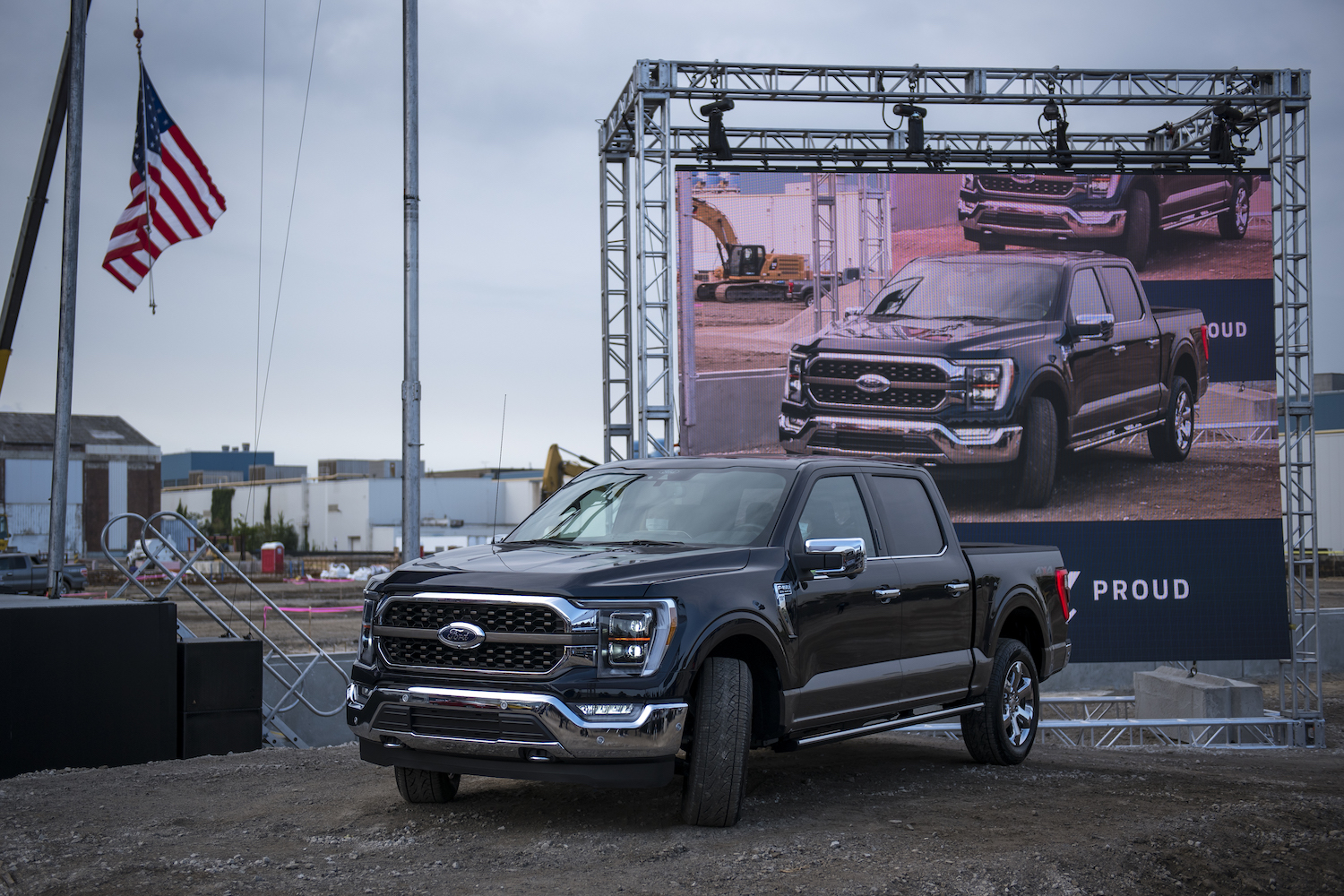 The 2021 Ford F-150 in black, with an American flag above it