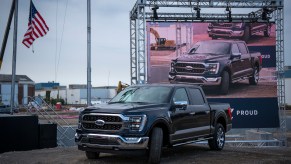The 2021 Ford F-150 in black, with an American flag above it
