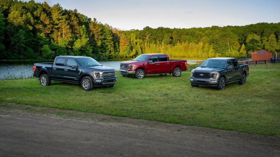 Left to right: 2021 Ford F-150 Limited in Smoked Quartz Tinted Clearcoat, F-150 Lariat in Rapid Red Metallic Tinted Clearcoat, and F-150 XLT Sport Appearance Package in Carbonized Gray.