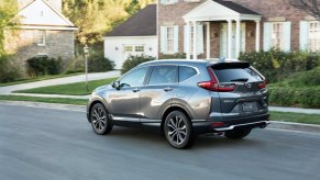 2021 Honda CR-V Touring is a compact SUV seen driving in a neighborhood