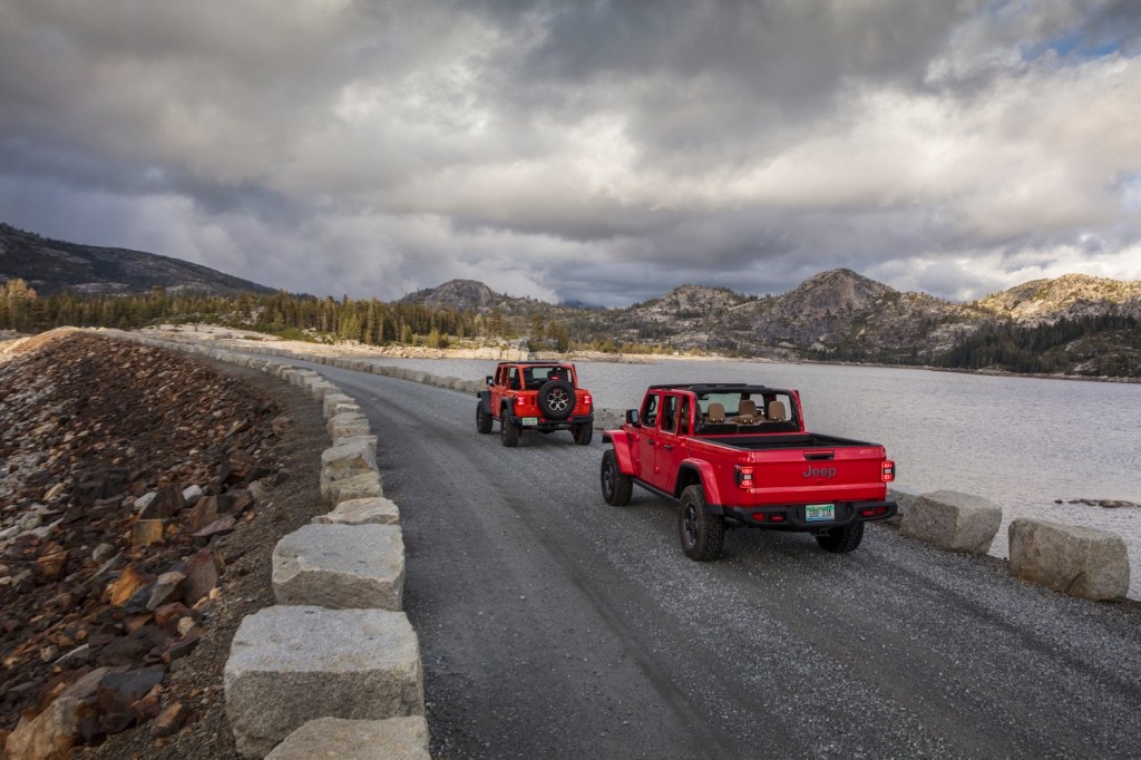 The 2021 Jeep Gladiator and Jeep Wrangler being driven on a cloudy day