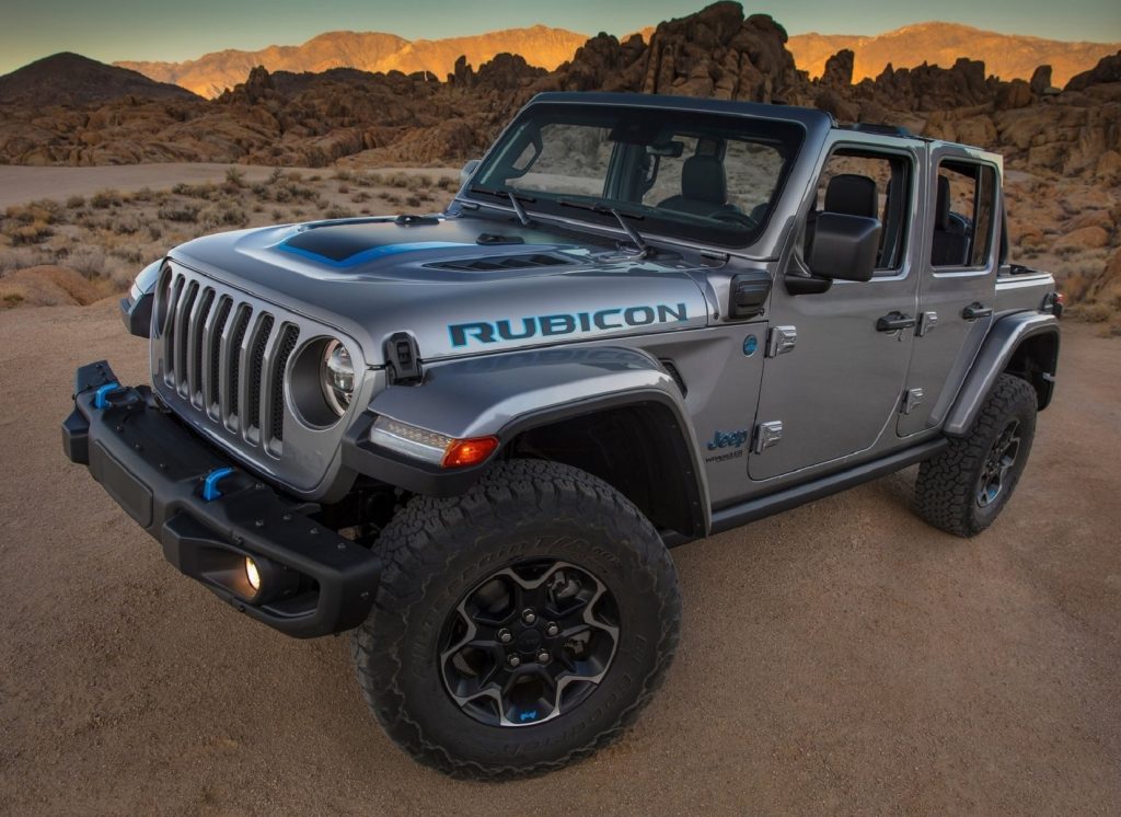 A close-angle front 3/4 view of a gray 2021 Jeep Wrangler Rubicon 4xe in the desert mountains