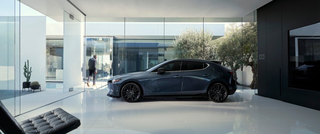 a side shot of the 2021 Mazda3 Hatchback in a showroom