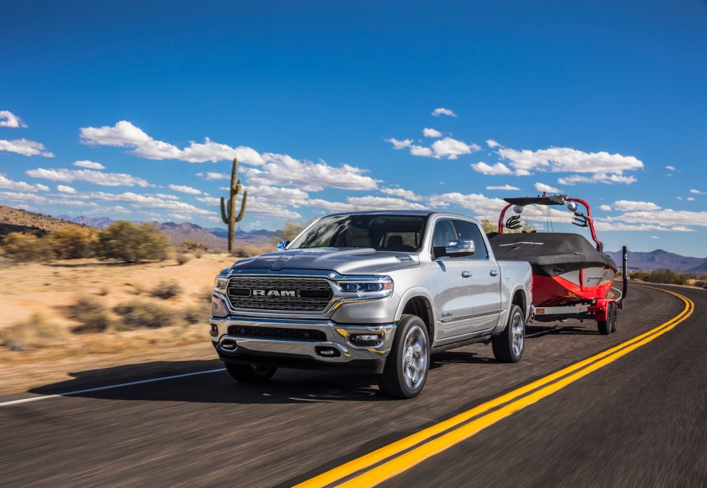 Pictured is one of the best trucks for towing, the 2021 Ram 1500 Limited, as it tows a boat.