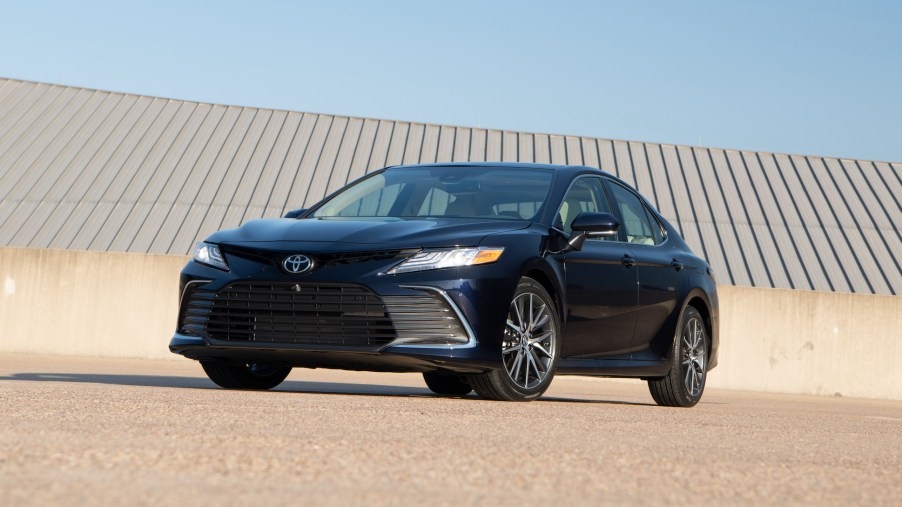 A dark-blue 2021 Toyota Camry XLE midsize sedan parked on a roof on a clear day