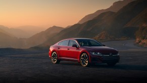 A red 2021 Volkswagen Arteon parked at a mountain overlook