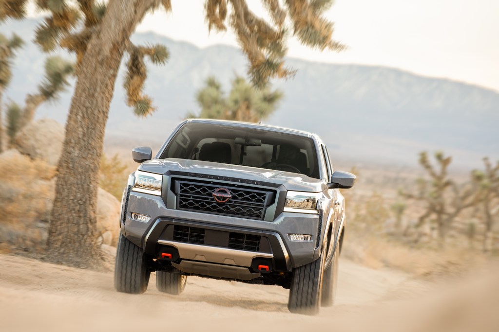 The resale value of a 2022 Nissan Frontier, like this one driving in the desert, is estimated to be higher than most other vehicles'