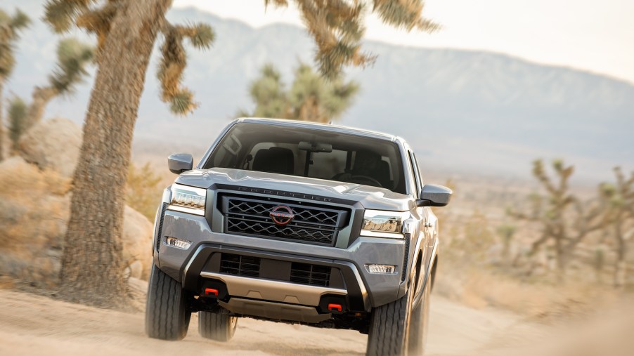 An image of a 2022 Nissan Frontier off-roading in dirt