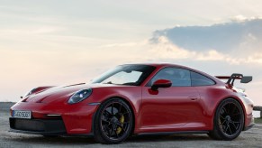 A red 2022 Porsche 911 GT3 parked on a gravel lot