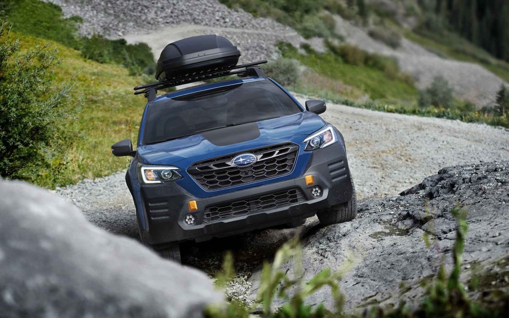 2022 Subaru Outback Wilderness Edition driving up a craggy rock