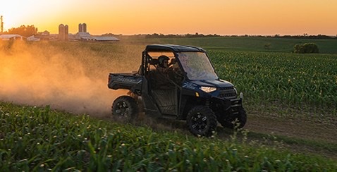 a Polaris Ranger driving between to corn fields is a side-by-side from the most popular ATV and UTV brand