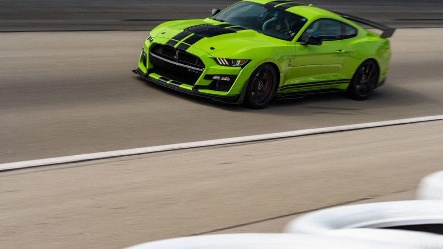 a bright green 2021 Shelby gt500 mustang taking a lap on the Texas motor speedway track