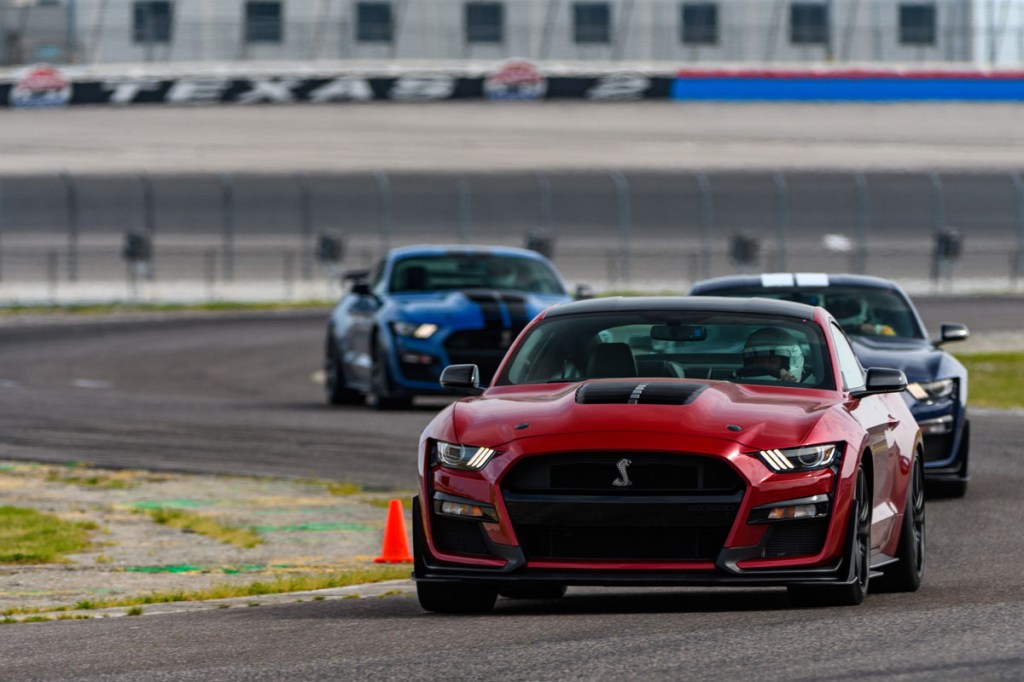 three Gt500 models in a row driving on the track
