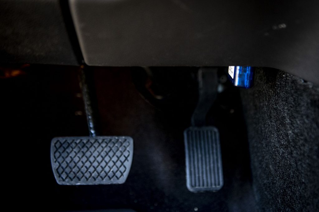 A blue Allstate Milewise dongle plugged into a car's OBD-II port