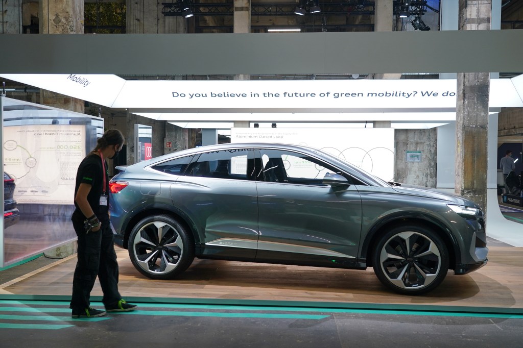 A gray Audi Q4 e-tron electric car stands on display at a press preview at the Greentech Festival