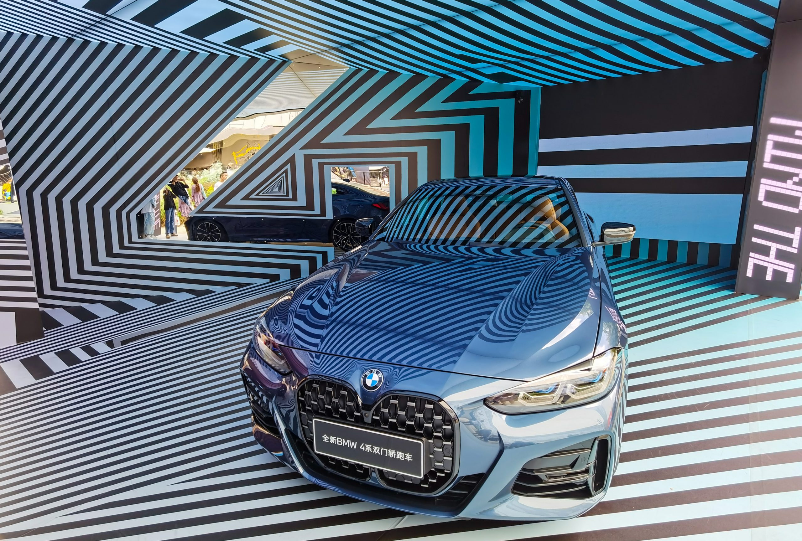 A BMW 4 Series sedan is on display at a shopping mall