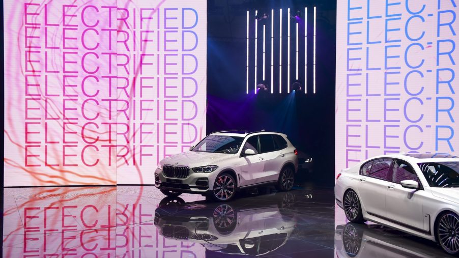 The Bayerische Motoren Werke AG white (BMW) X5 xDrive45e plug-in hybrid sports utility vehicle (SUV) is driven on to a stage on the opening day of the 89th Geneva International Motor Show