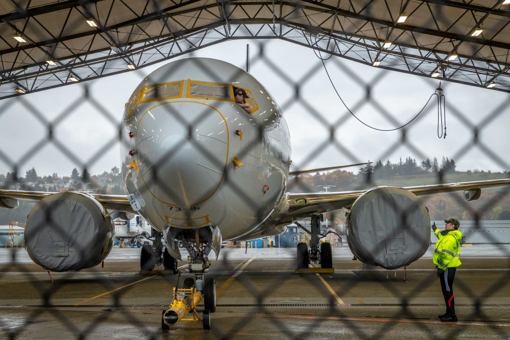 Boeing 737 Max plane behind fence