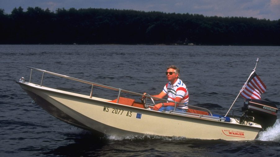 Test engineer William MacDonald, in sunglasses, taking his new Boston Whaler motor boat for a spin