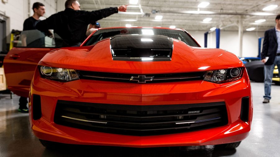 Tour attendees view a General Motors Co. Chevrolet COPO Camaro inside the company's build center in Oxford, Michigan, U.S.