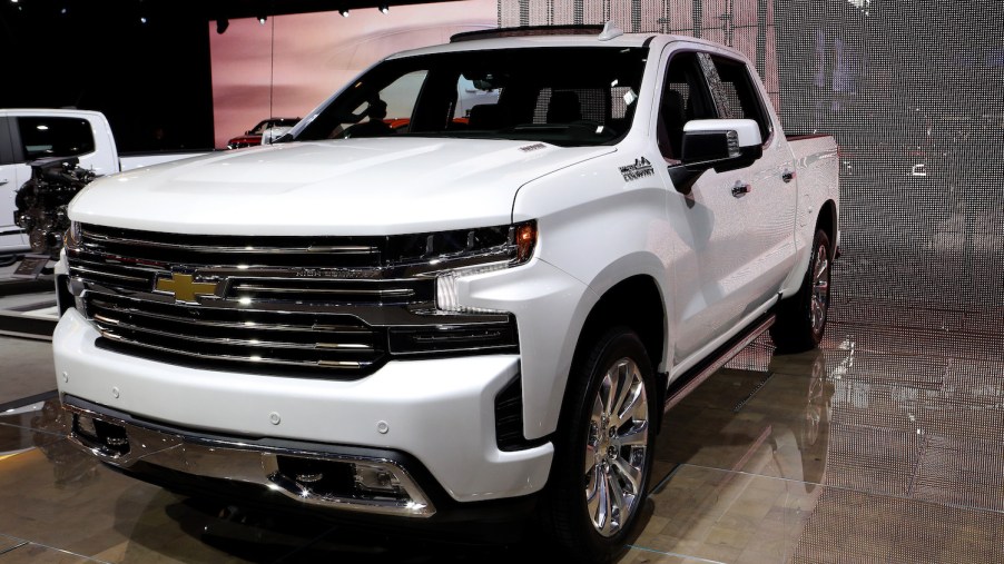 A white Chevy Silverado pictured at an auto show.