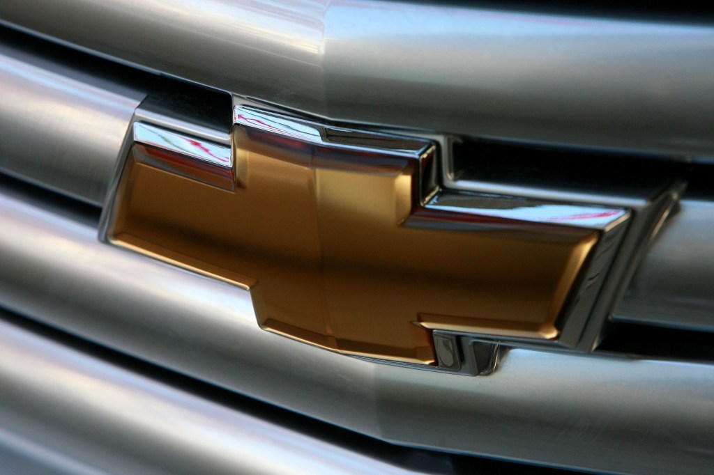 A gold chevy logo on a silver vehicle grille