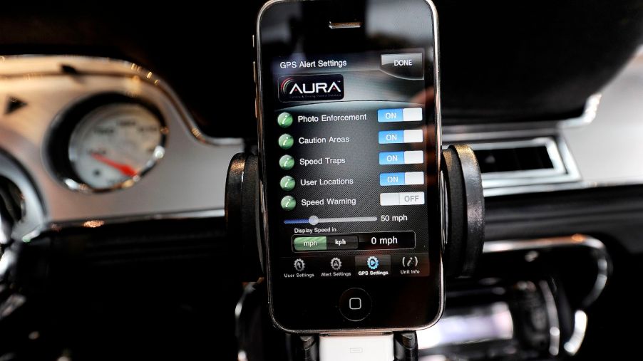 A Cobra radar detector app on an iPhone mounted in a 1967 Shelby Cobra GT500 CR