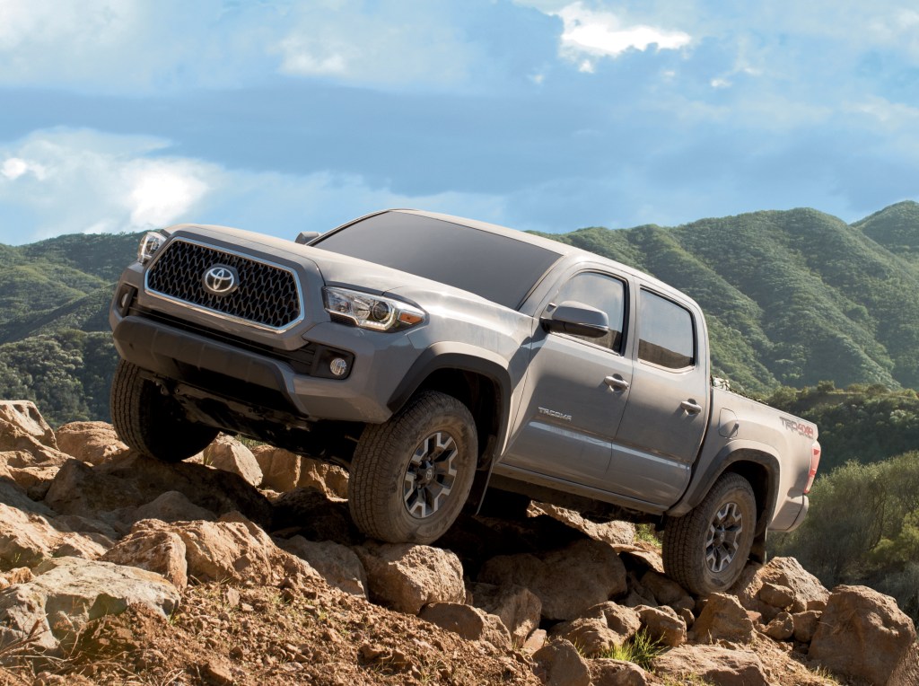 2021 Toyota Tacoma climbing rocks in remote and mountainous terrain.