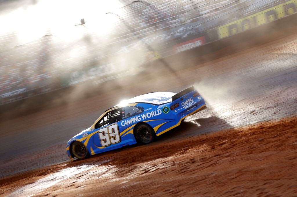 Daniel Suarez slides the blue #99 Chevrolet at the 2021 NASCAR Cup Series Food City Dirt Race at Bristol