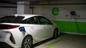 A white Toyota Prius connected to an EV charging station in a Washington, D.C. parking garage on Wednesday, March 31, 2021