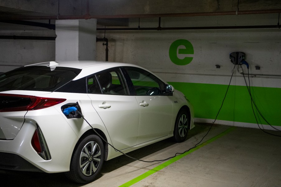 A white Toyota Prius connected to an EV charging station in a Washington, D.C. parking garage on Wednesday, March 31, 2021