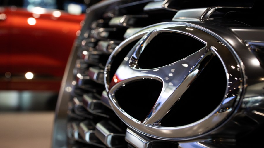 The Hyundai logo seen on the front grille of a Palisade