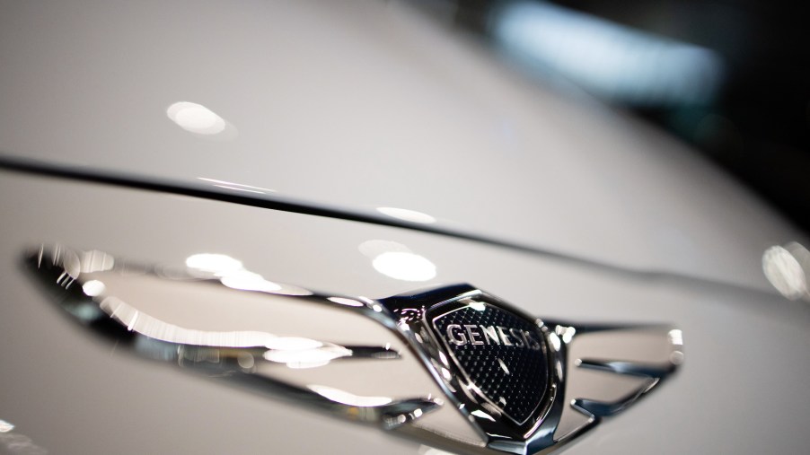 The Hyundai Motor Co. Genesis badge is displayed on the hood of a white vehicle at the company's Motorstudio showroom in Goyang, South Korea, on Friday, July 19, 2019