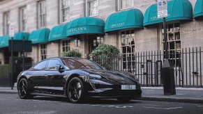 An image of a Black Porsche Taycan parked outdoors in one of the worst car colors for resale.