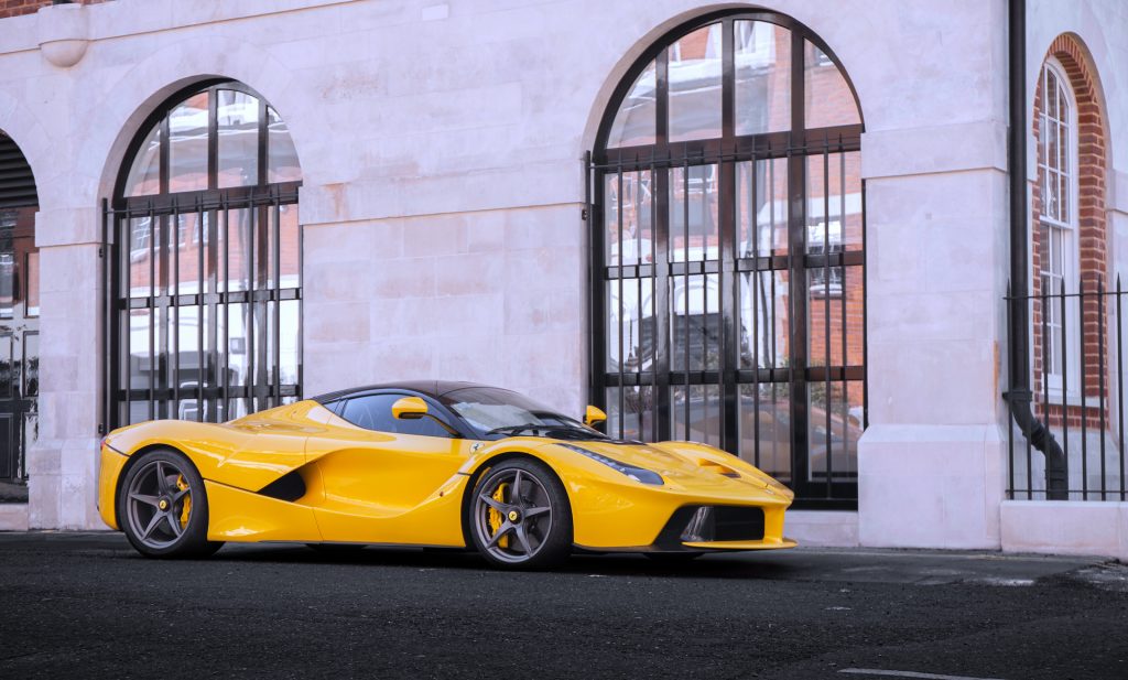 An image of a Yellow Ferrari LaFerrari parked outdoors.