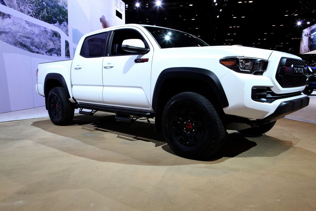 a white and 2017 Toyota Tacoma TRD Pro on display at an auto show