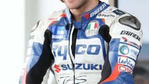 Guy Martin in a blue-white-and-red BMW-branded leather racing suit at the 2013 Cemetery Circuit Motorcycle Races in New Zealand