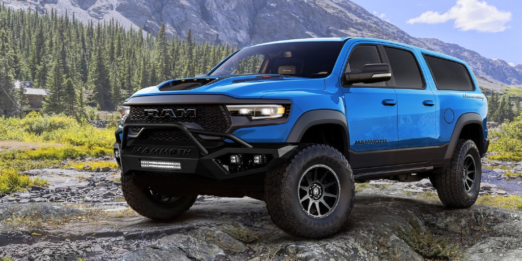 A blue Hennessey Mammoth 1000 SUV in the mountains
