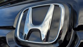 Close-up of Honda logo on hood ornament of a car