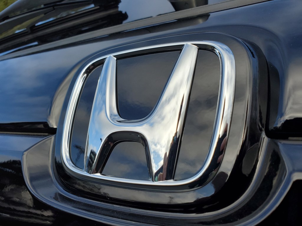Close-up of Honda logo on hood ornament of a car