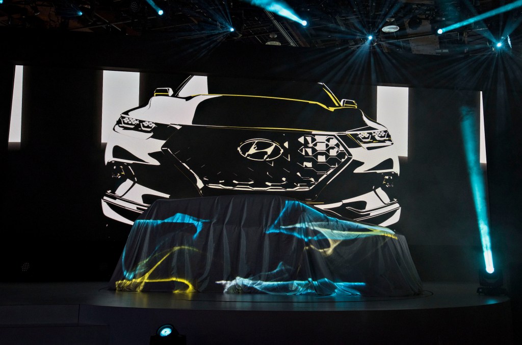 A Hyundai Motor Co. Santa Cruz Concept vehicle sits under a sheet prior to its unveiling during the 2015 North American International Auto Show