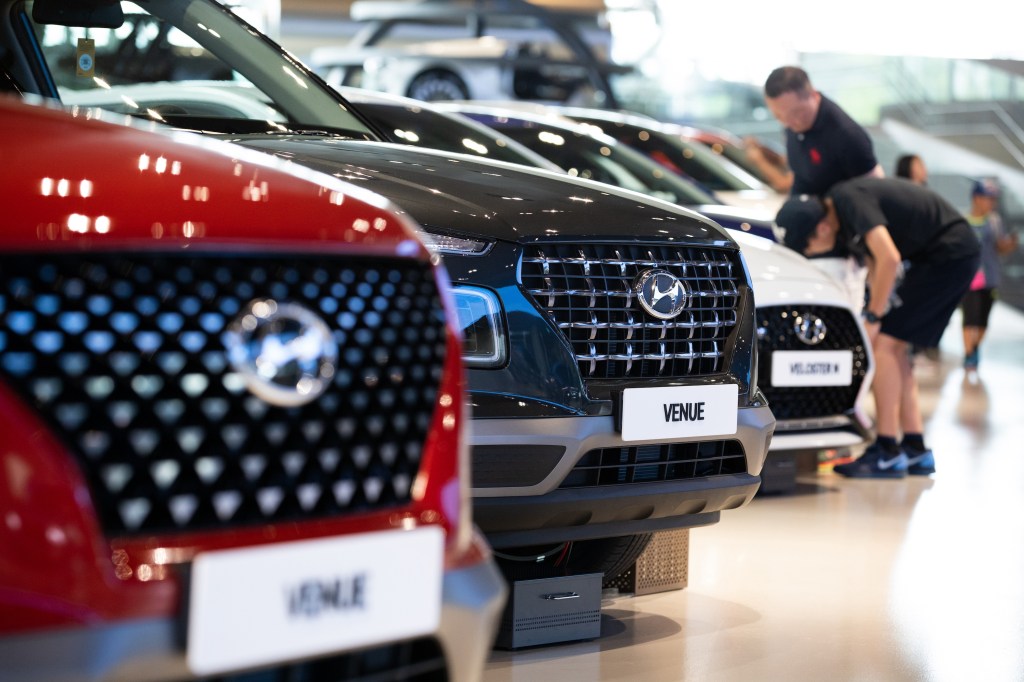A Hyundai Motor Co. Venue compact sport utility vehicle (SUV), center, stands on display at the company's Motorstudio showroom in Goyang, South Korea