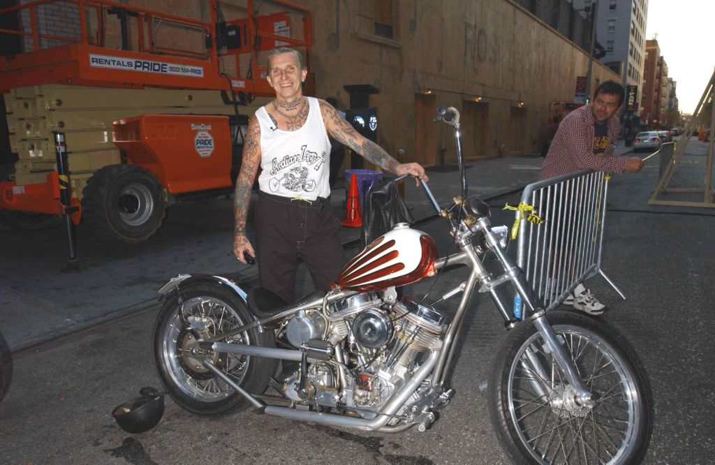 Indian Larry on the street outside of The Late Show with Dave Letterman Show with one of his custom red-and-white-painted choppers