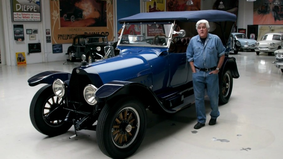 Jay Leno with his blue 1916 Owen Magnetic in his garage