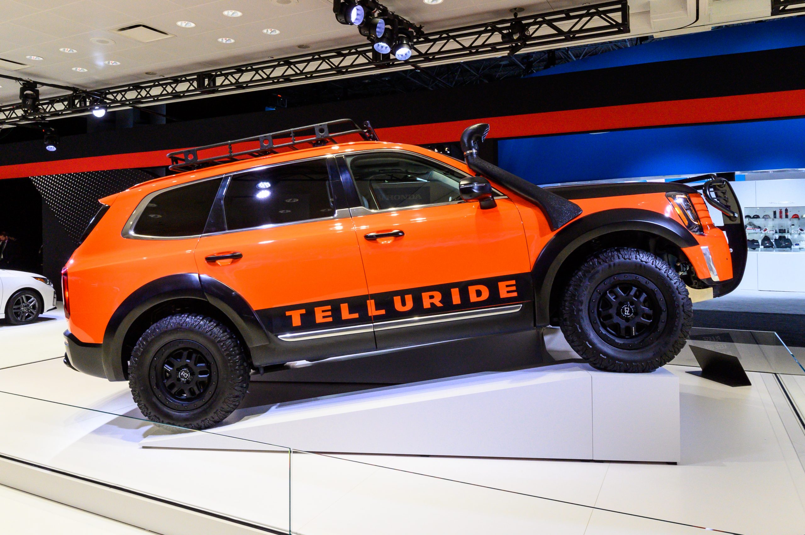 Orange Kia Telluride with roof rack seen at the New York International Auto Show at the Jacob K. Javits Convention Center in New York